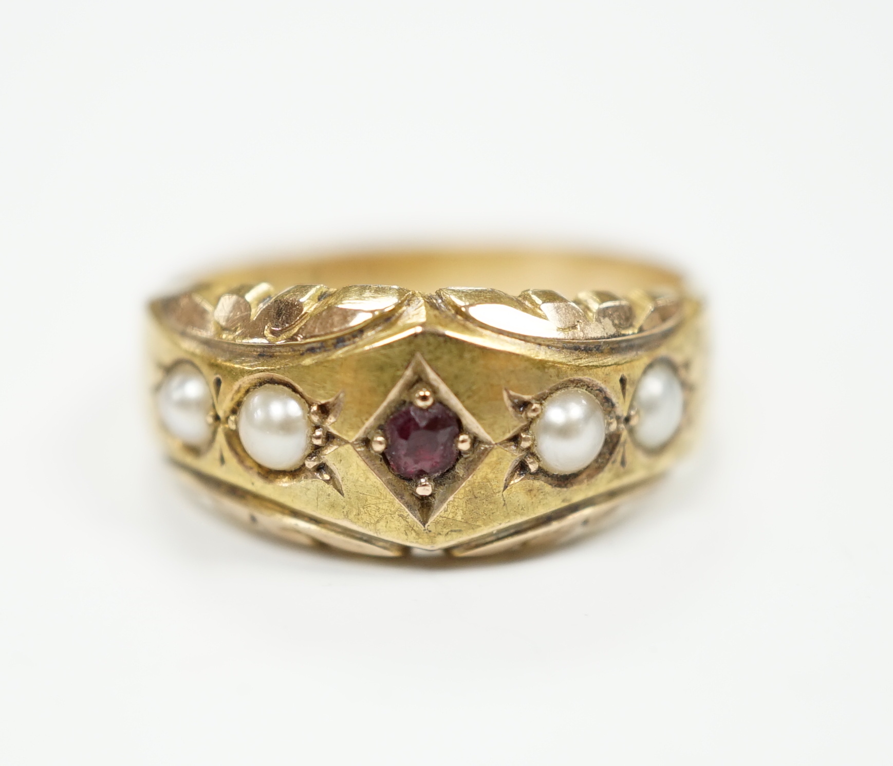 A late Victorian 15ct gold, ruby and split pearl set half hoop ring, size M, gross weight 2.7 grams.